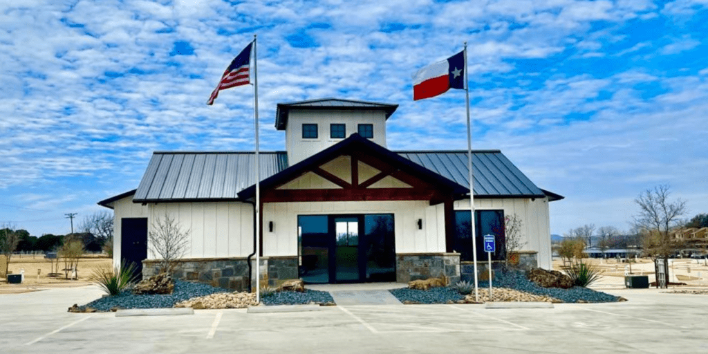 A building with two flags in front of it.