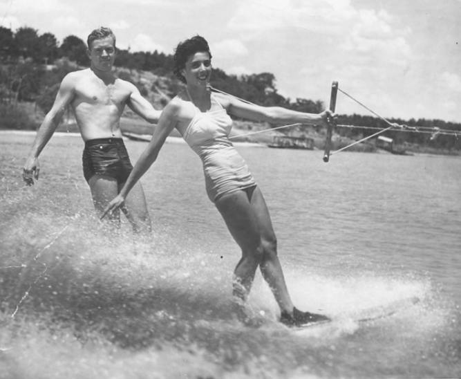 A man and woman water skiing in the ocean.