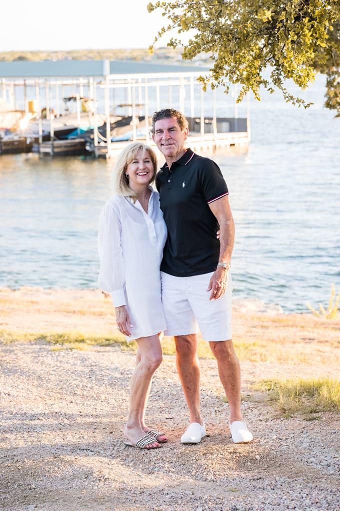 A man and woman standing next to each other on the beach.