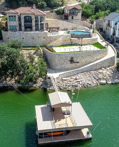 A boat is docked in the water near some houses.