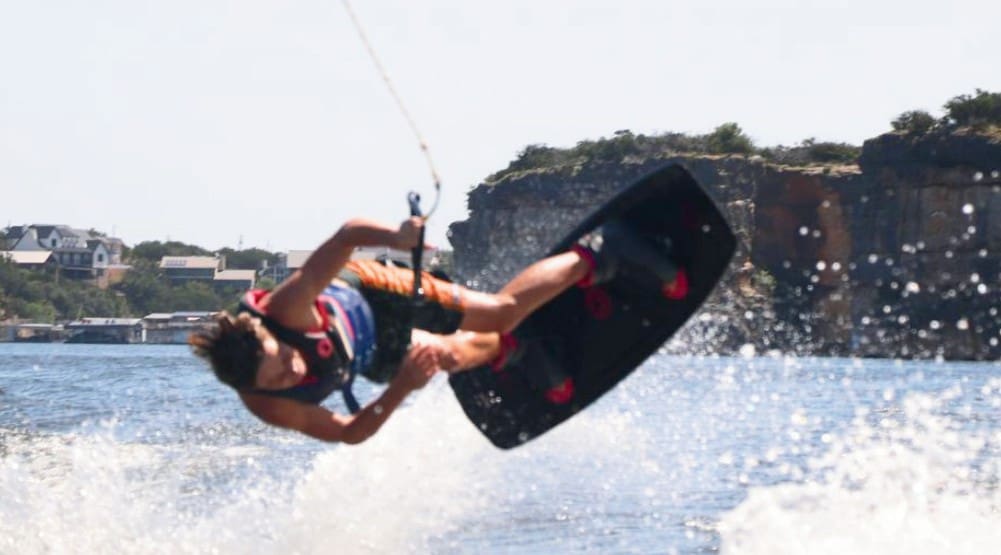 A person wakeboarding with water splashing around.