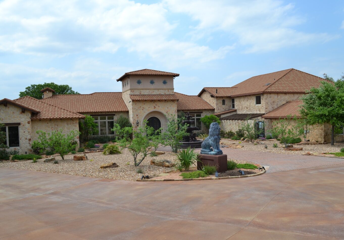 A large brick building with a statue in the middle of it.